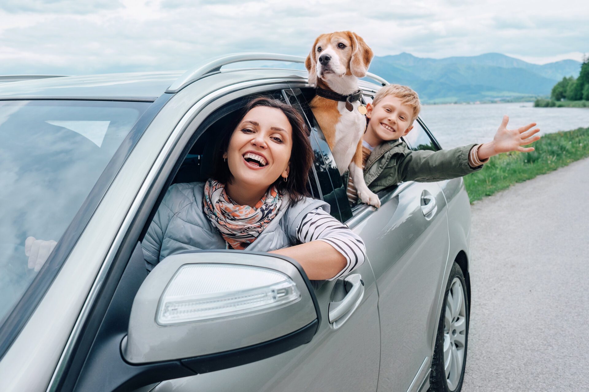Happy family look out from car windows Insurance